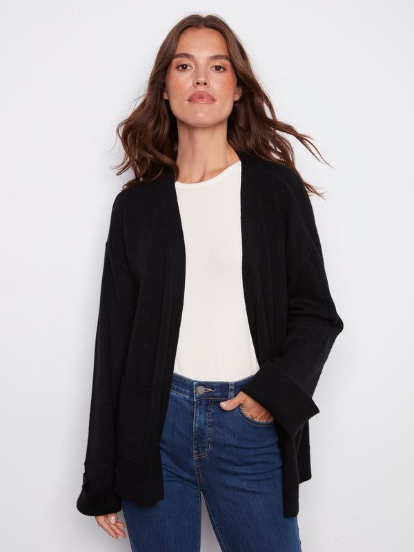 Black cardigan featuring wide cuffs for a modern touch, perfect for layering and adding style to any outfit by Charlie B.
