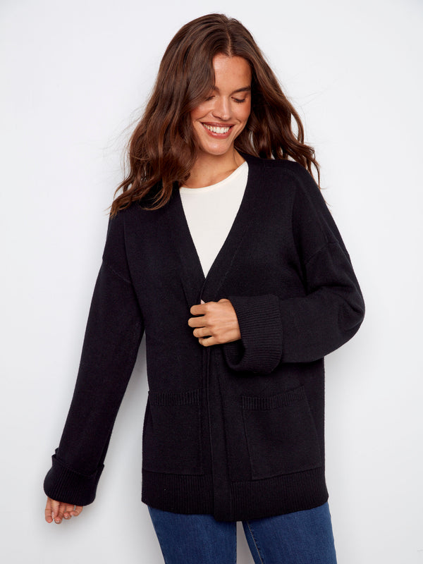 Stylish black long-sleeve cardigan with convenient patch pockets, combining functionality with fashion by Charlie B.
