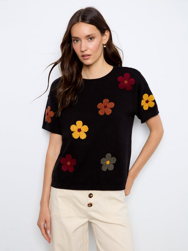 Black sweater with floral embroidery and crew neck design, crafted from 100% cotton for comfort by Charlie B.
