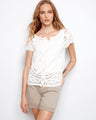 This white crochet top features a scoop neckline, adding elegance to any outfit. Made from 100% cotton for comfort and style by Charlie B.