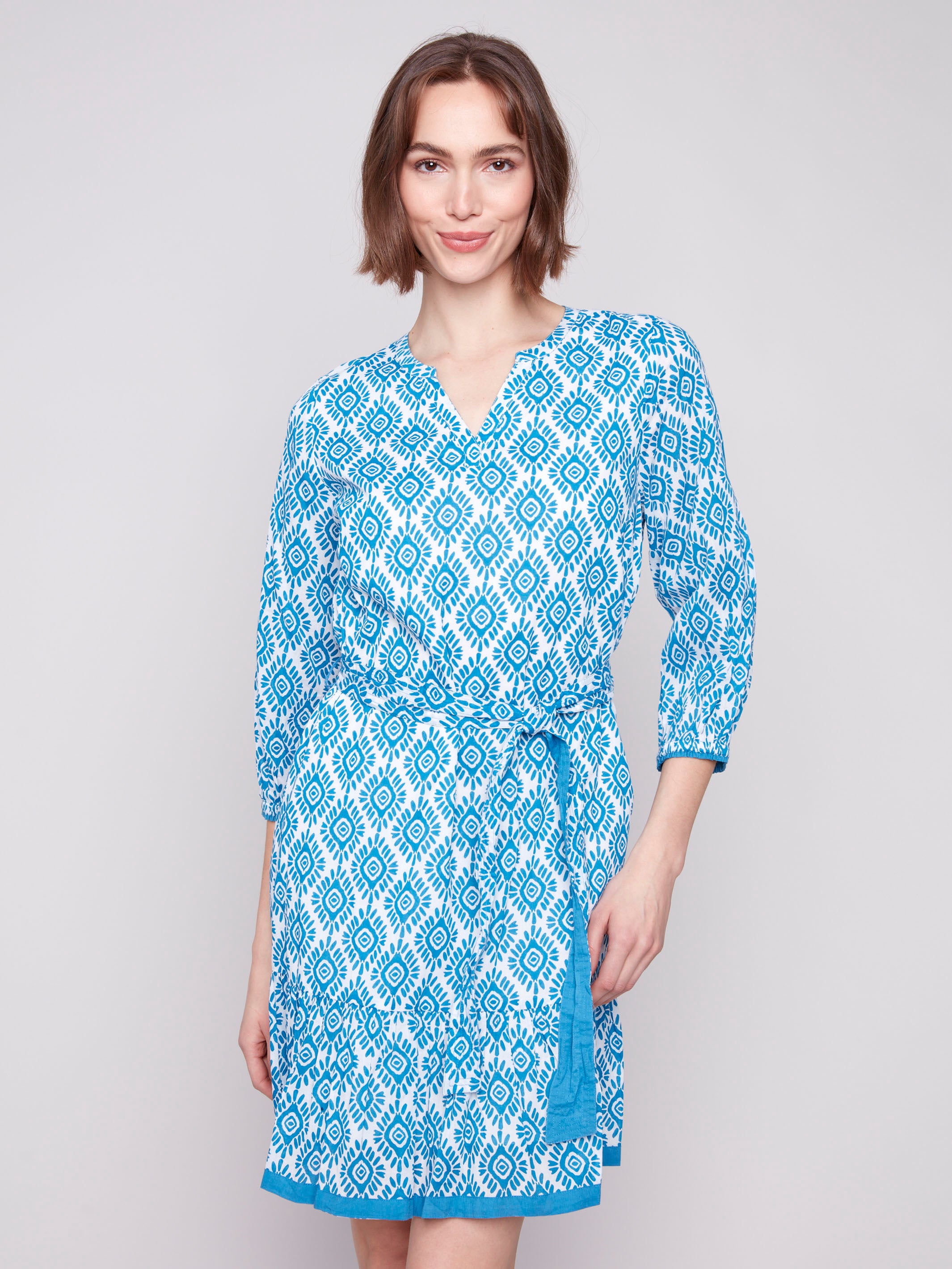 Elegant dress featuring knee length and elastic cuffs by Charlie B.