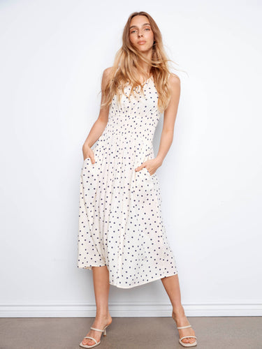 Stylish white polka dot dress showcasing its elegant v-neckline and hidden pockets by Charlie B.