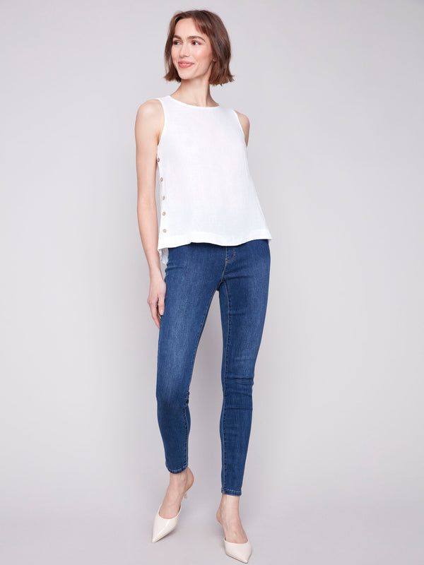 Fashionable white tank with unique button accents on the side by Charlie B.