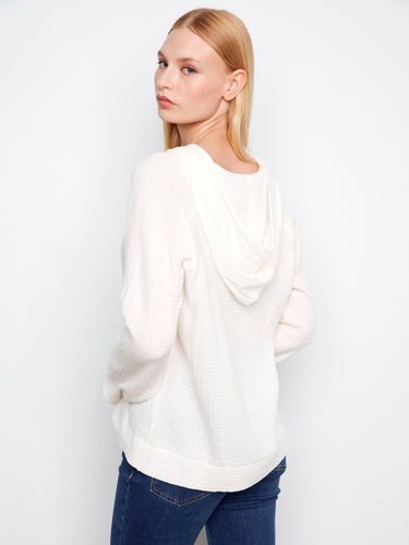 Elegant white hoodie showcasing a classic kangaroo pocket. Experience the softness of 100% cotton material by Charlie B.