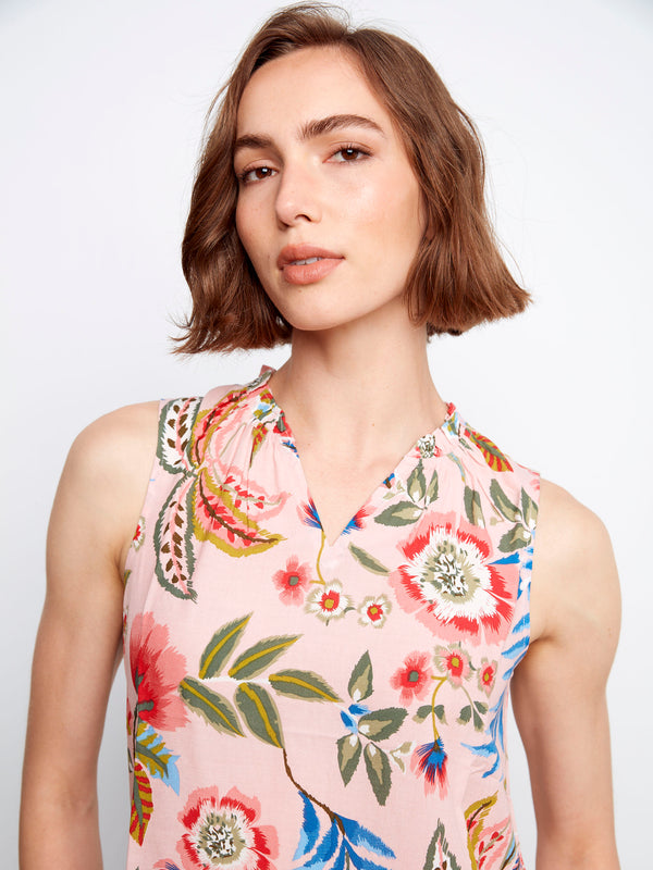 A sleeveless floral blouse that embodies both fashion and function, perfect for layering or wearing alone. By Charlie B.