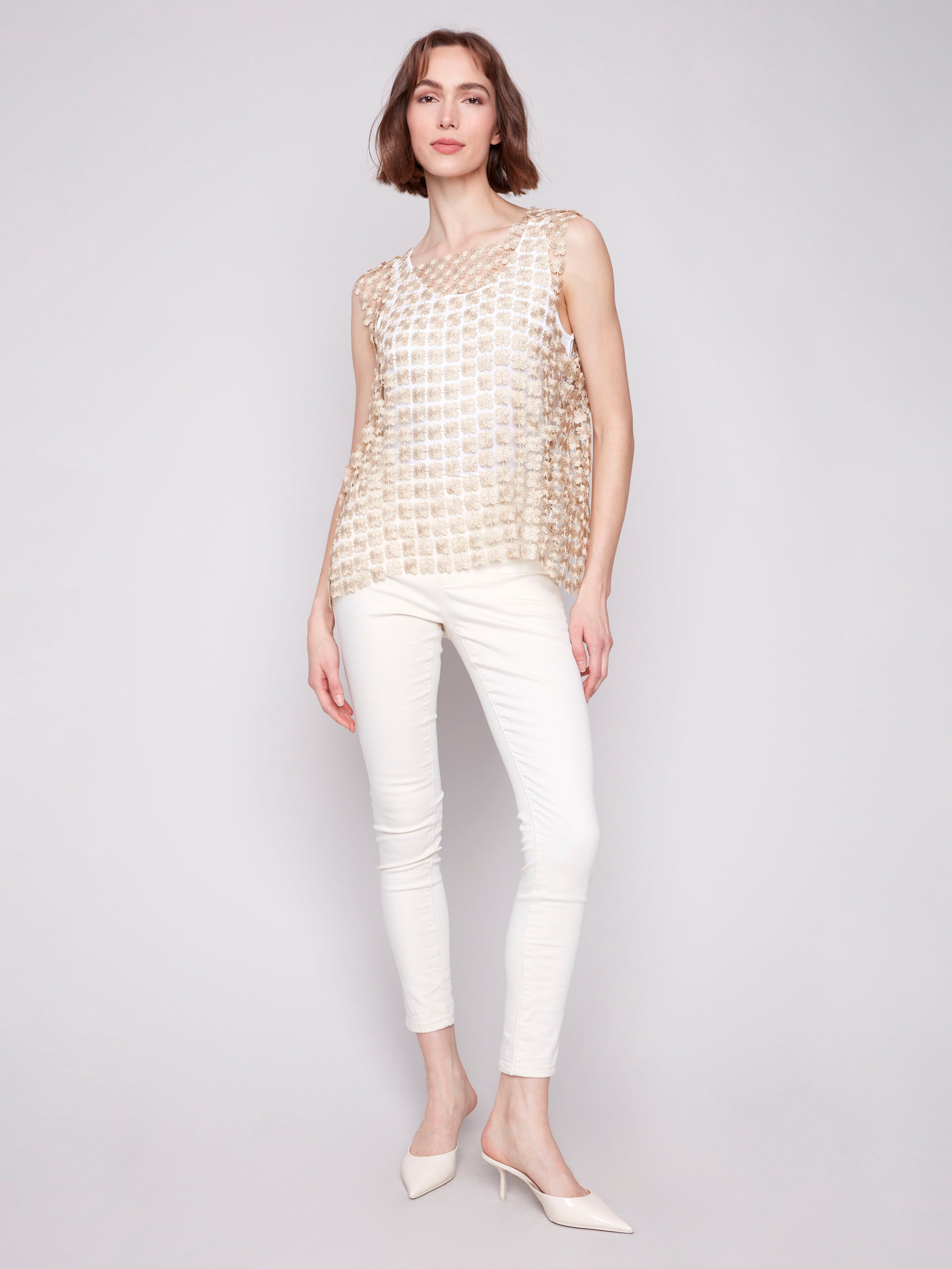 Textured floral pattern on gold crochet top by Charlie B.