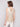 Unique square neckline on a gold crochet garment by Charlie B.