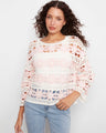 Crochet top with a boat neckline, showcasing intricate patterns and delicate design in a soft cotton blend. By Charlie B.