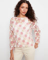 Crochet top in white with pink floral accents, featuring a boat neckline and 3/4 sleeves. Perfectly crafted by Charlie B.