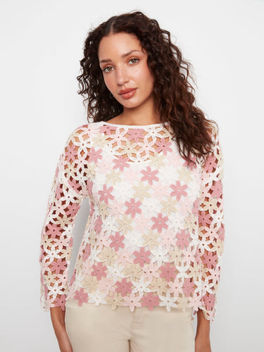 White crochet top adorned with pink florals, highlighting the unique boat neckline for added flair. By Charlie B.