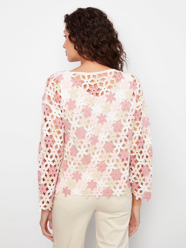 Stylish crochet top in white with pink flower motifs, designed with drop shoulders for comfort. Crafted by Charlie B.