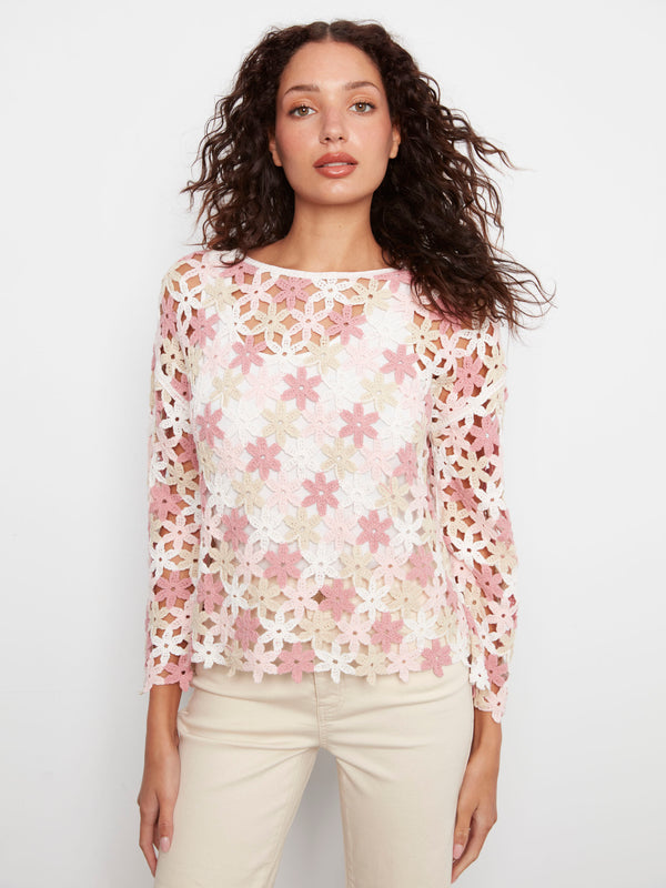 White crochet blouse embellished with charming pink flowers, offering a classic look made from cotton blend by Charlie B.