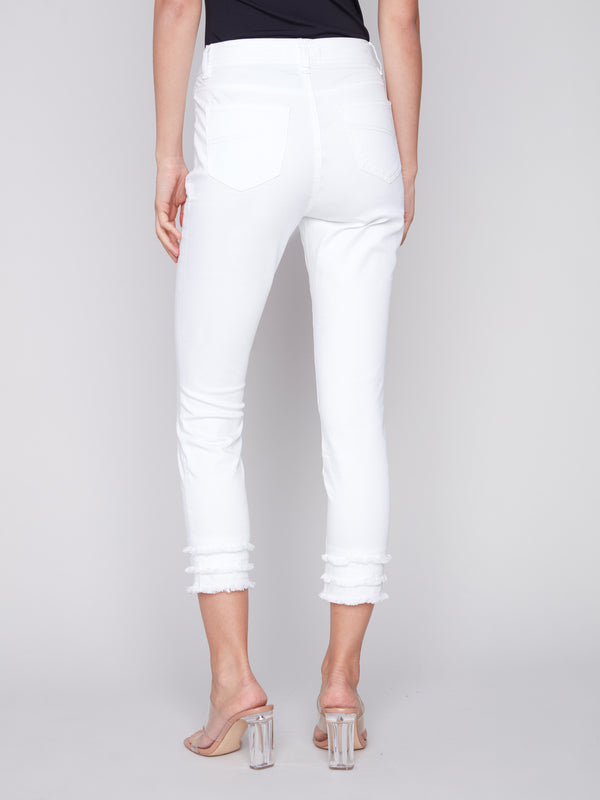 Frayed hem detail on white pants with regular rise waist, offering comfort and style by Charlie B.