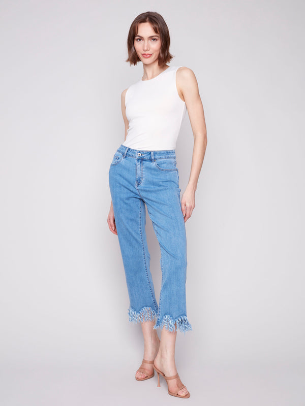 Blue cropped jeans with a fashionable fringed hem and bootcut leg design by Charlie B.