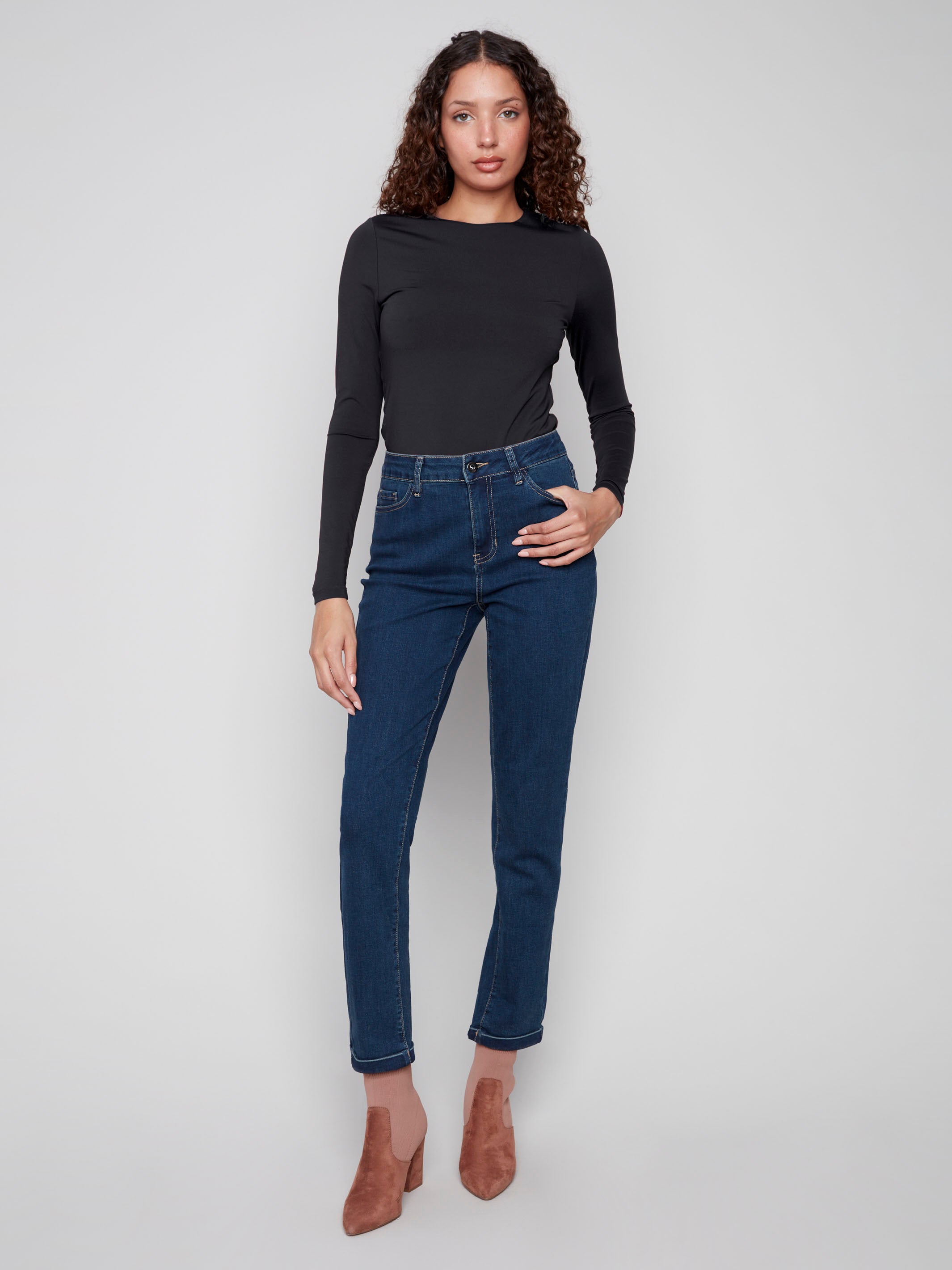 Dark blue jeans with a slim fit, showcasing a regular rise and stretch denim for comfort by Charlie B.