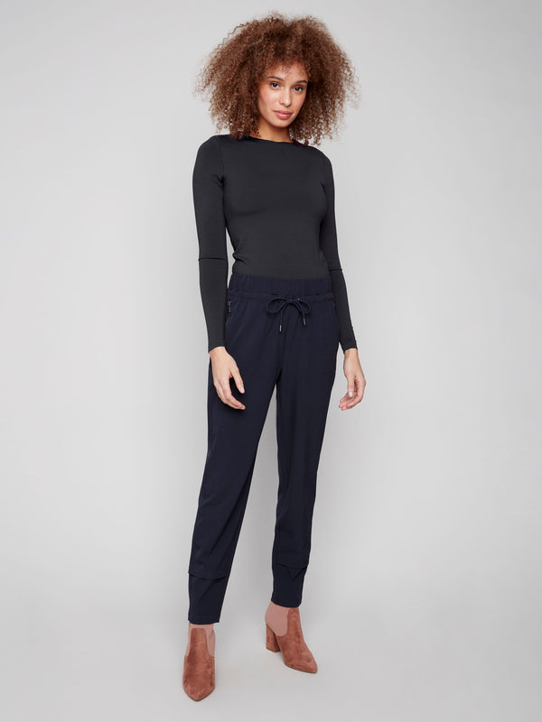 Navy techno pants with a relaxed slim-leg fit, featuring an elastic waistband and drawstring by Charlie B.