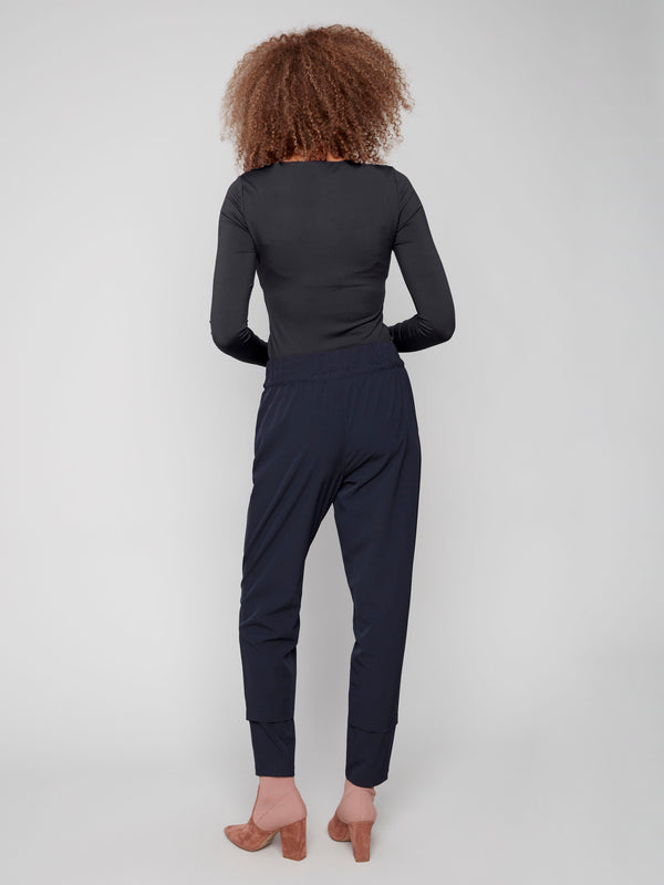 Navy slim-leg techno pants with adjustable waistband, side pockets, and drawcords by Charlie B.