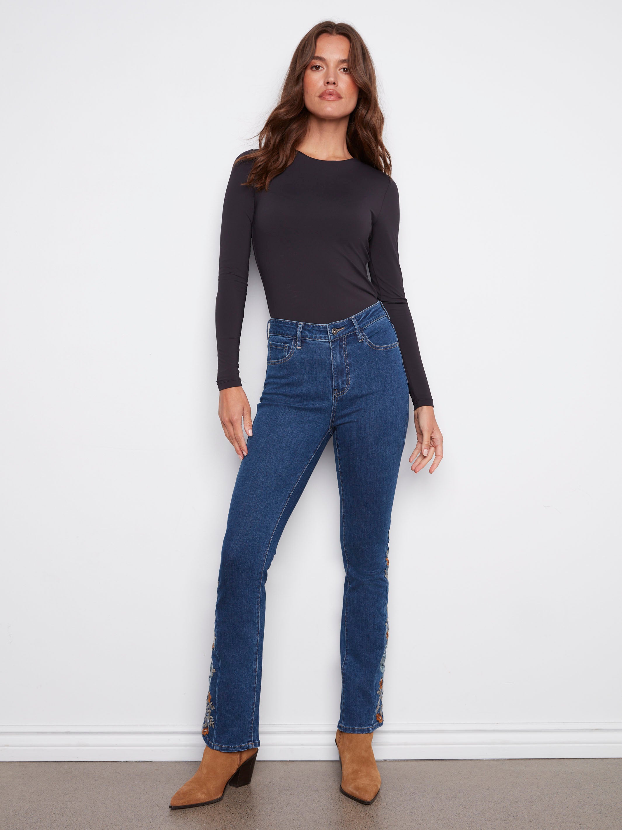 Indigo jeans with floral embroidery and a bootcut fit, offering a stylish long length by Charlie B.