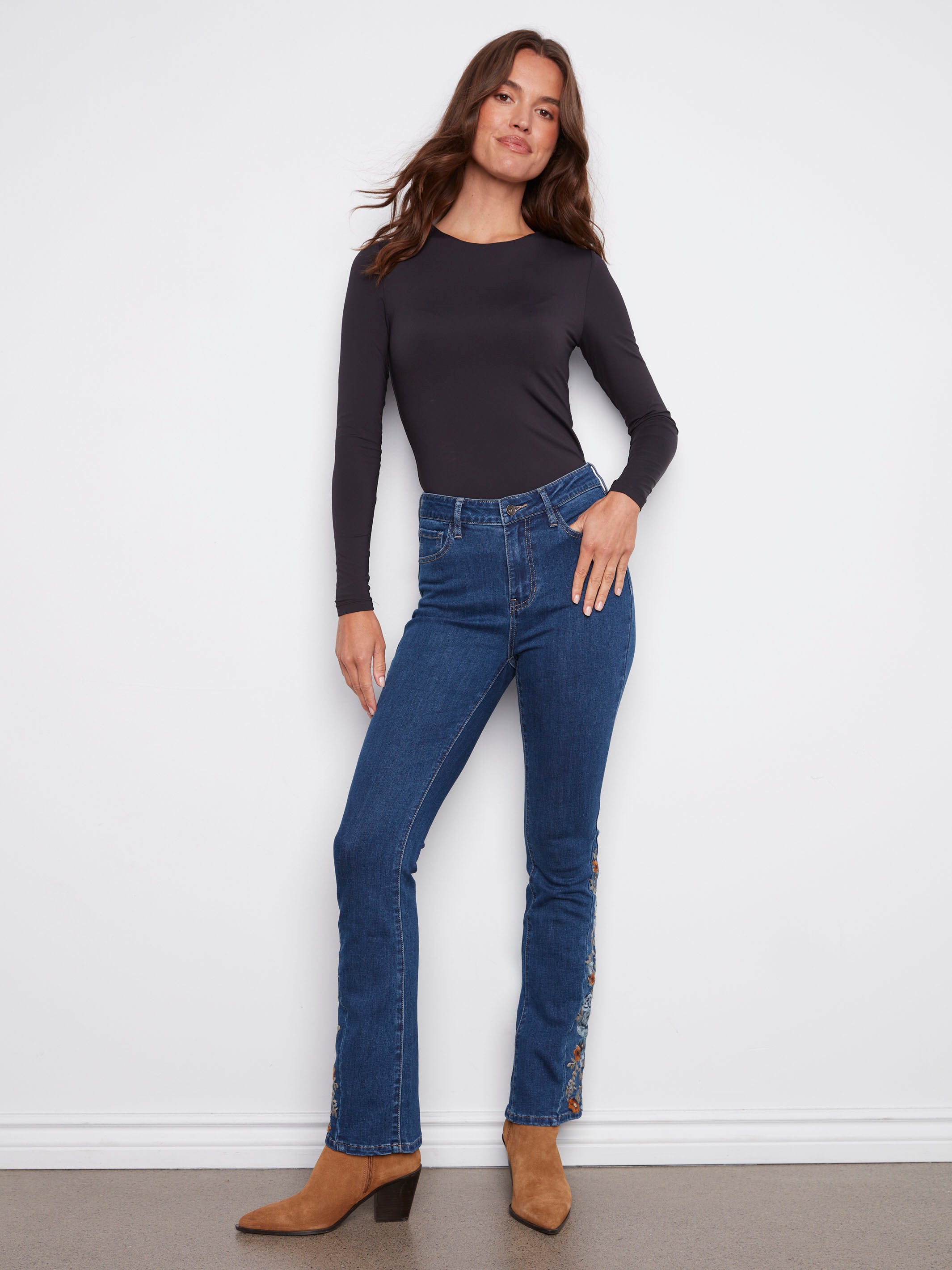Regular rise indigo jeans with intricate floral embroidery along the sides, crafted from stretch denim by Charlie B.