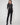 Black slim-fit dress pants with stretch fabric, featuring two back welt pockets for added style and comfort by Charlie B.