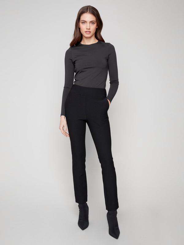 Elegant black dress pants with a slit at the hem, offering a contemporary twist on classic tailoring by Charlie B.