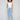 Light blue slim leg jeans with five-pocket design and button closure by Charlie B.