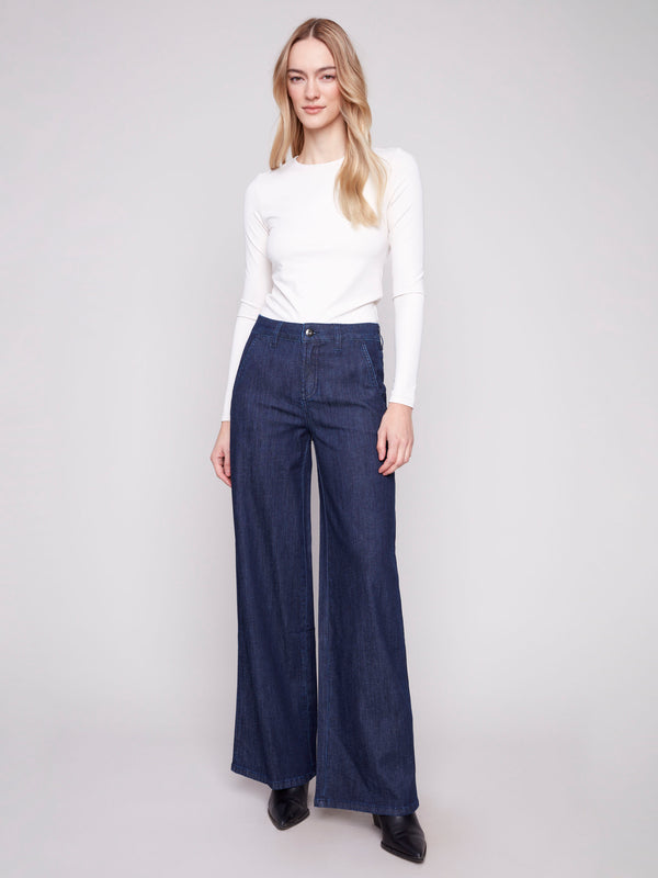 Blue-black wide-leg jeans with a button front closure and slash pockets by Charlie B.