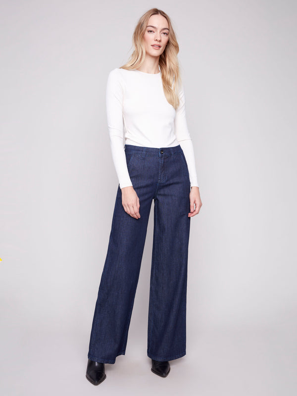 Blue-black wide-leg jeans with a button front closure and slash pockets by Charlie B.