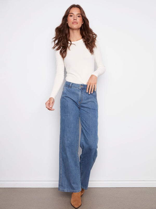 Blue jeans featuring a long length design and button front, perfect for any occasion by Charlie B.