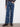 These indigo jeans showcase a raw hem and charming flower patches, adding flair to any outfit by Charlie B.