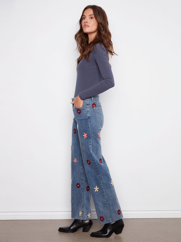 Stretch denim in medium blue with delightful flower patches adds flexibility to your wardrobe by Charlie B.