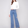 Medium blue jeans featuring a five-pocket design and floral embroidery for a chic look by Charlie B.