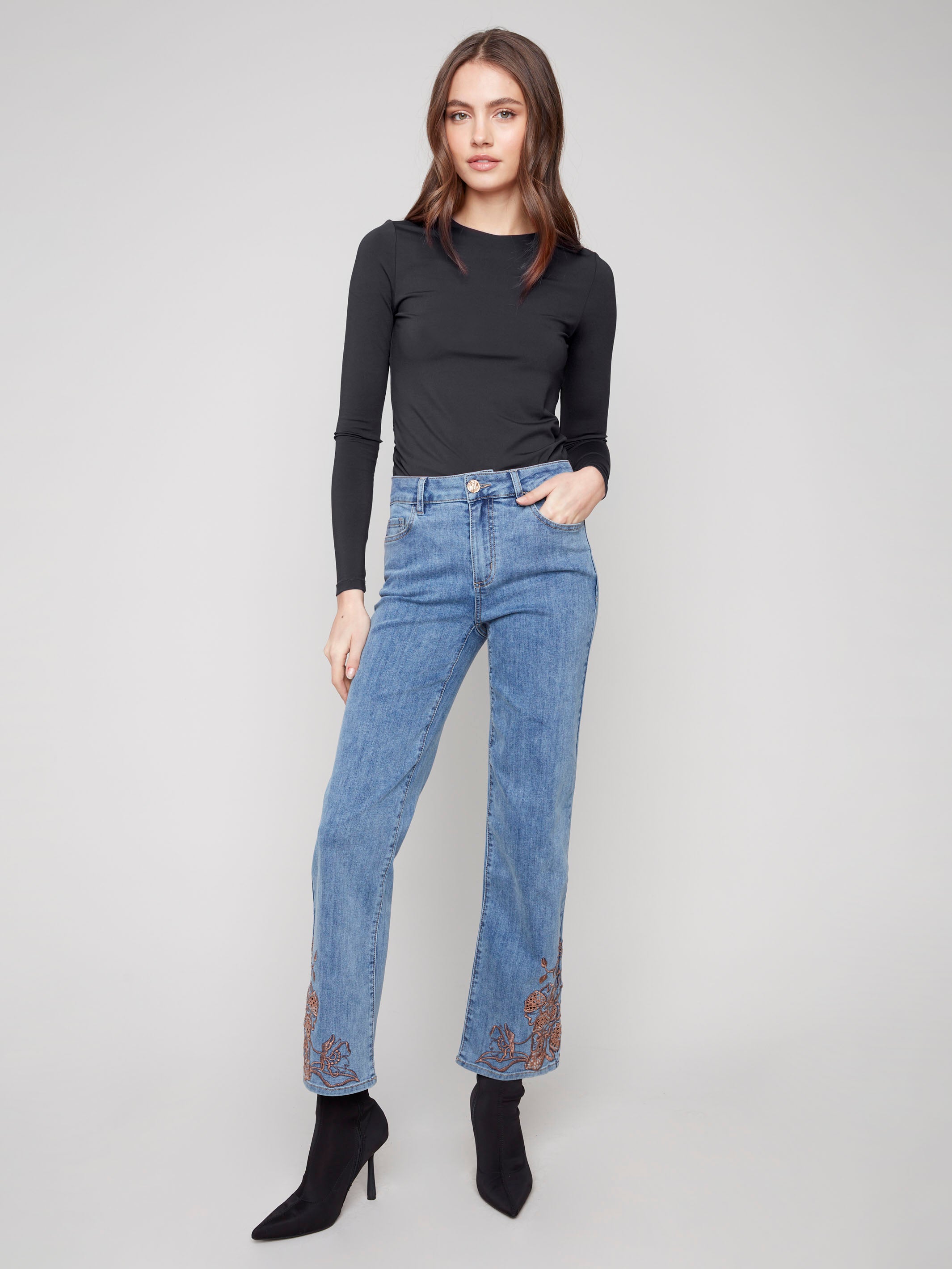 Medium blue jeans with a straight leg cut, featuring a regular rise and detailed lace embroidery for added style by Charlie B.