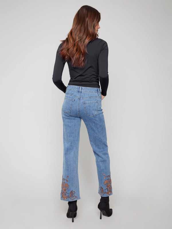 Five-pocket jeans in medium blue tone, designed for both fashion and function with beautiful hem embroidery accents by Charlie B.