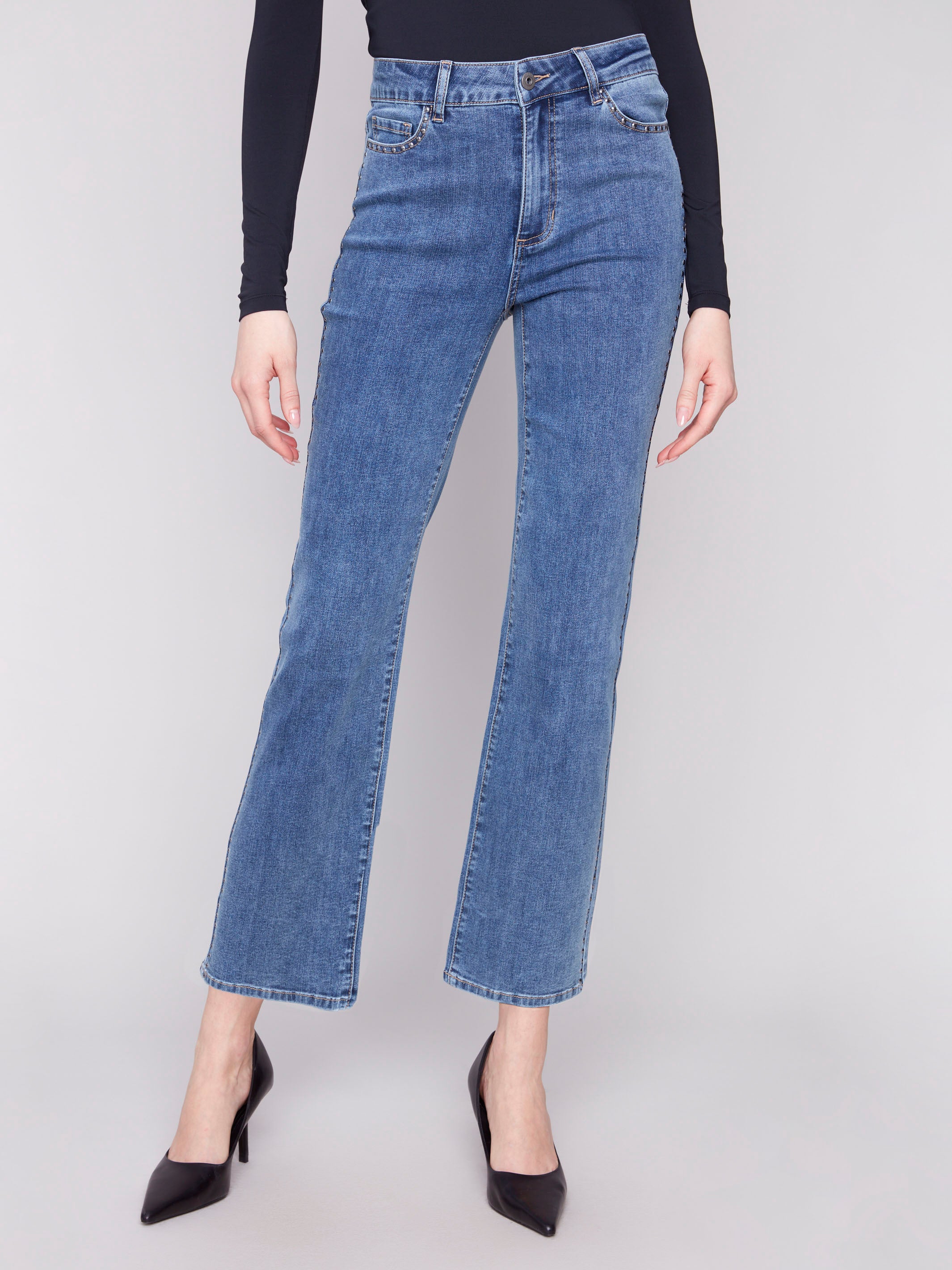 Denim jeans in medium blue, featuring studs on the pockets and sides for a trendy look by Charlie B.