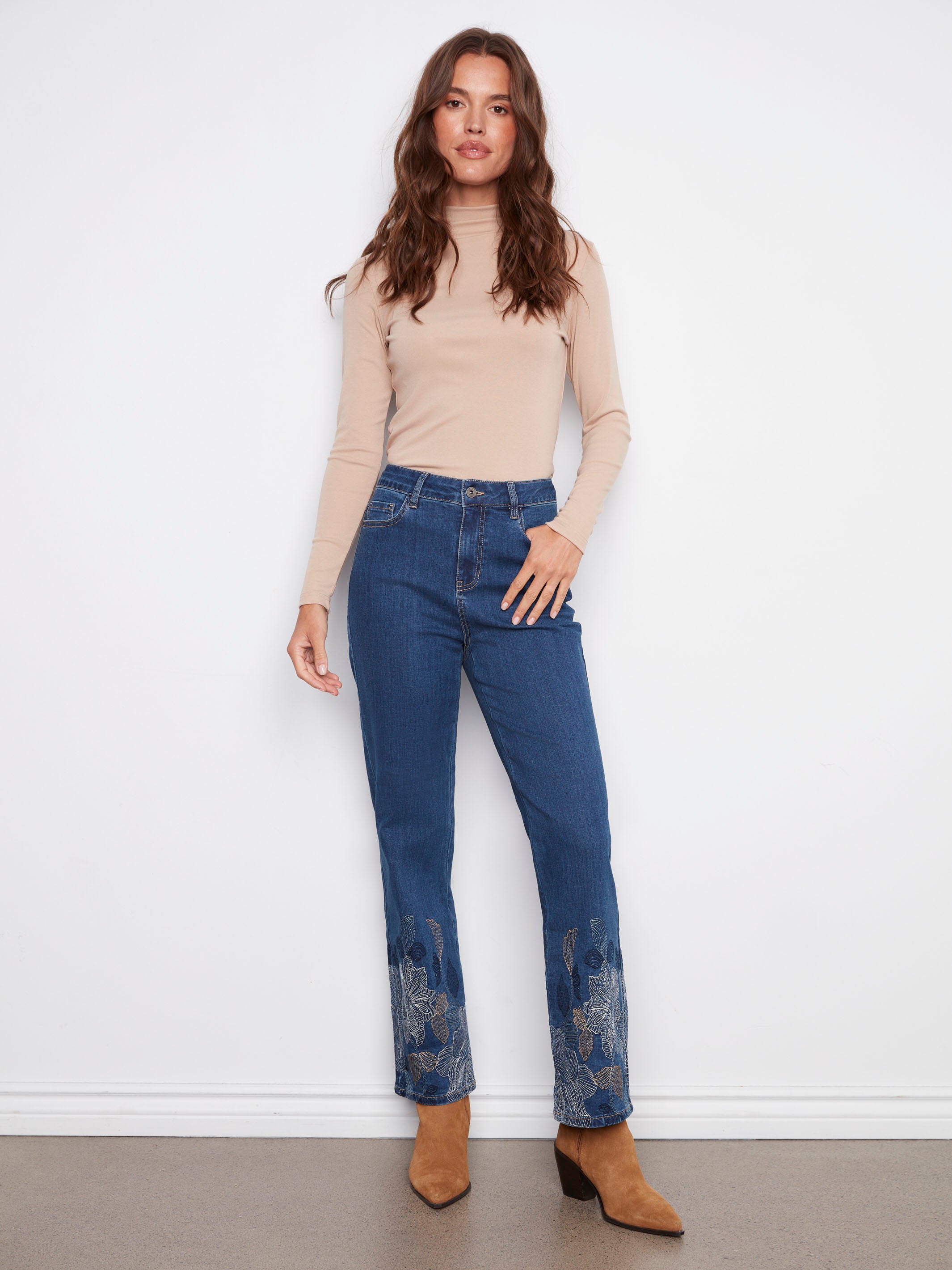 Indigo jeans featuring a straight fit and metallic floral hem embroidery, perfect for a chic look by Charlie B.