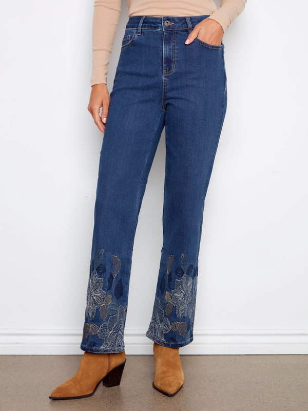 These indigo jeans boast a five-pocket design with exquisite metallic floral embroidery at the hem by Charlie B.