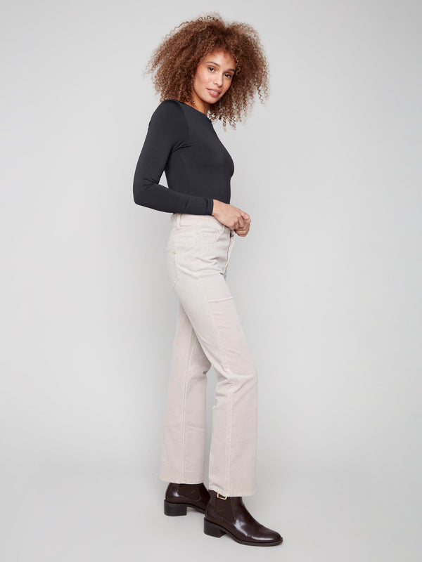 Elegant oat corduroy pants showcasing a five-pocket design for functionality by Charlie B.