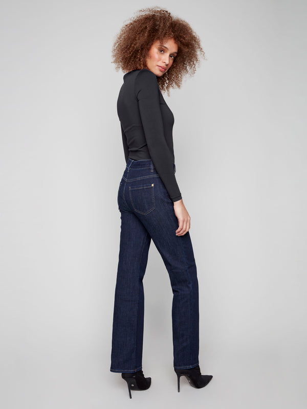 Deep blue flare leg jeans crafted from stretch denim, featuring long length elegance and back pocket design by Charlie B.