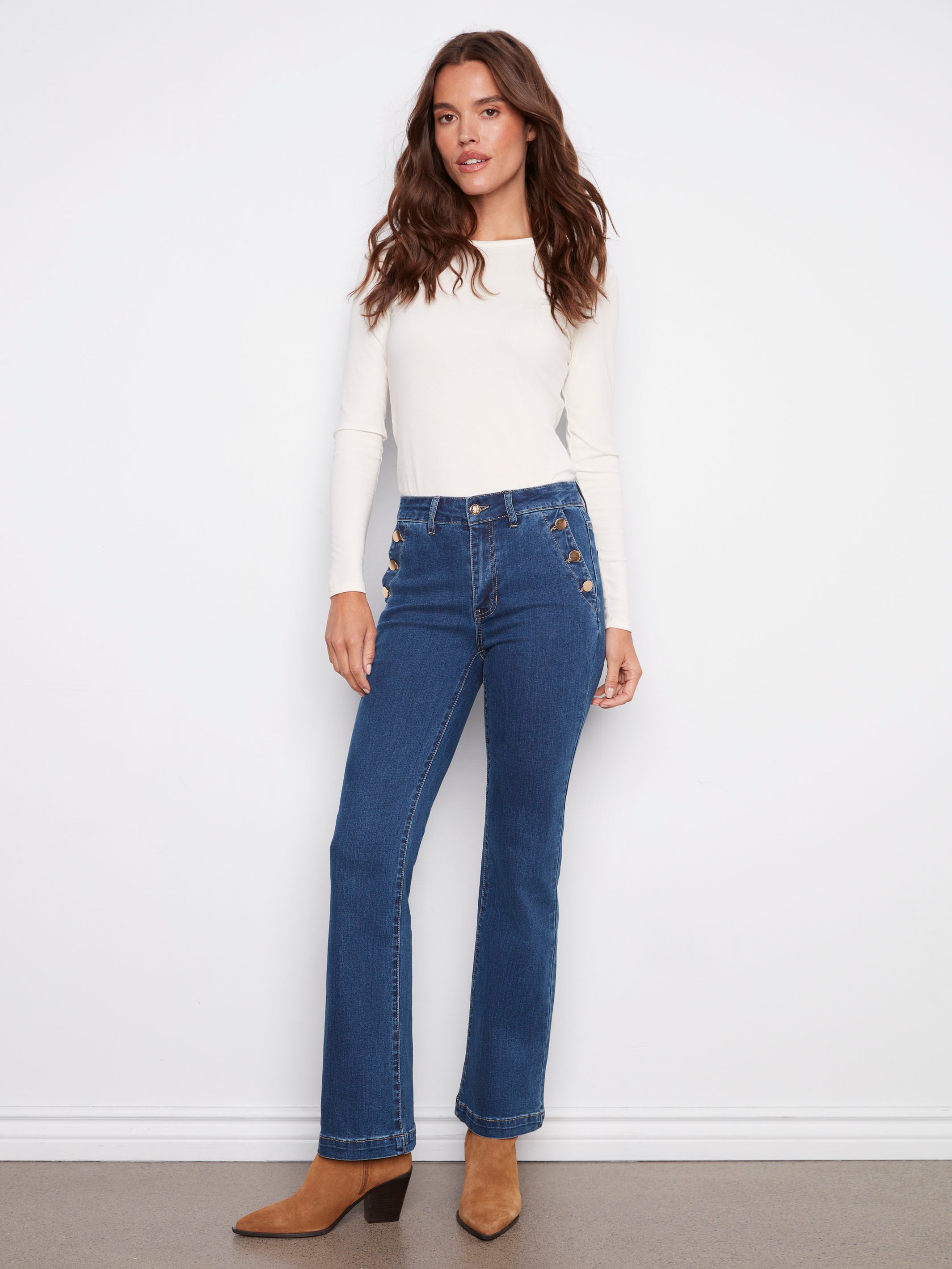 Indigo jeans with a regular rise and button details, crafted from stretch denim for comfort, designed by Charlie B.