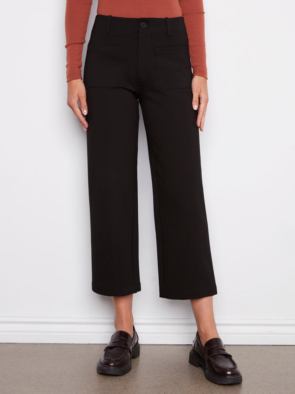 These black ponte pants showcase a zip fly with button closure, offering a sleek and comfortable fit by Charlie B.