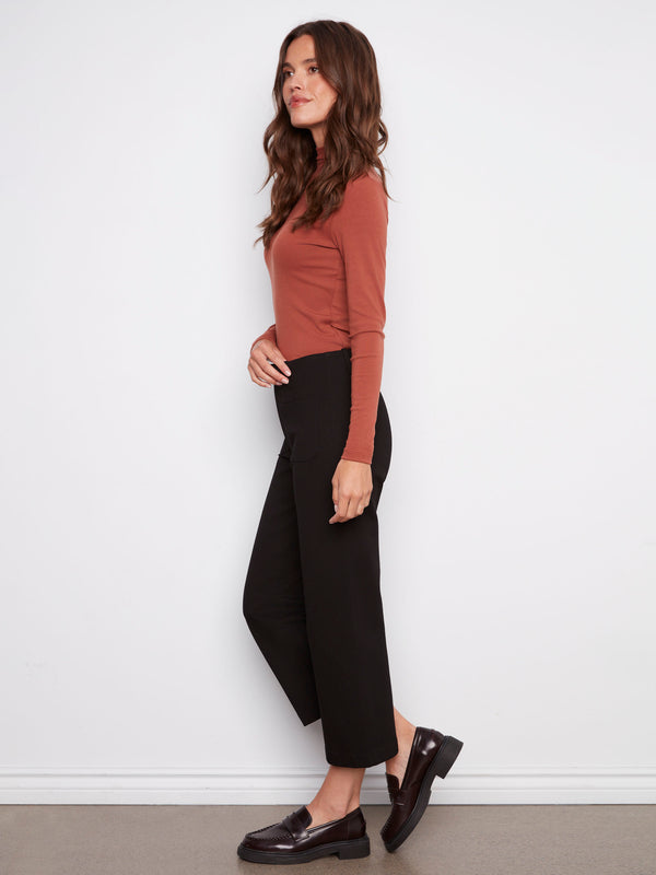 Featuring two back patch pockets, these black wide-leg ponte pants combine functionality and fashion effortlessly by Charlie B.