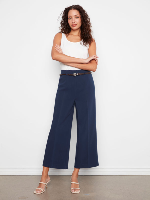 Wide leg navy pants designed with a trendy cropped length and adjustable belt detail by Charlie B.