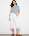 White cropped pants with intricate lace hem detail, offering a stylish touch to any outfit by Charlie B.
