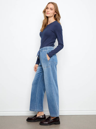 These medium blue jogger pants have slash pockets and a cropped length, offering both style and functionality by Charlie B.