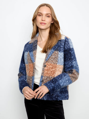 A stylish jacket with a tailored collar, featuring a bold checkered pattern in blue and brown hues. By Charlie B.