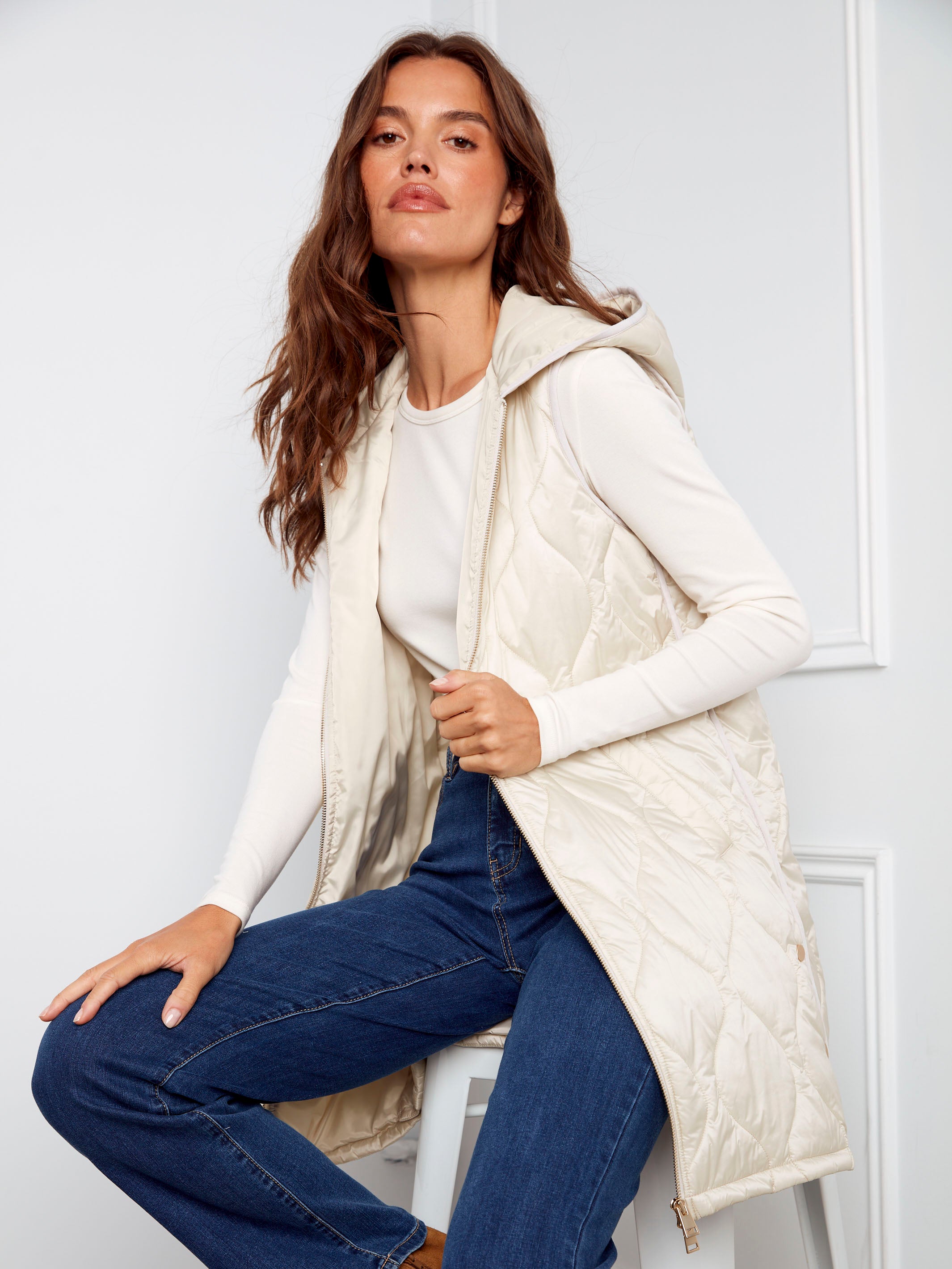 Champagne long hooded vest with a pearlized finish and welt pockets by Charlie B.