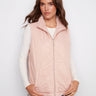 Chic ballet pink quilted vest featuring welt pockets for added style and convenience by Charlie B.