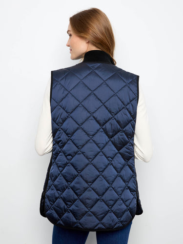 Quilted sleeveless vest designed with side zipper details for an edgy twist on classic outerwear. By Charlie B.