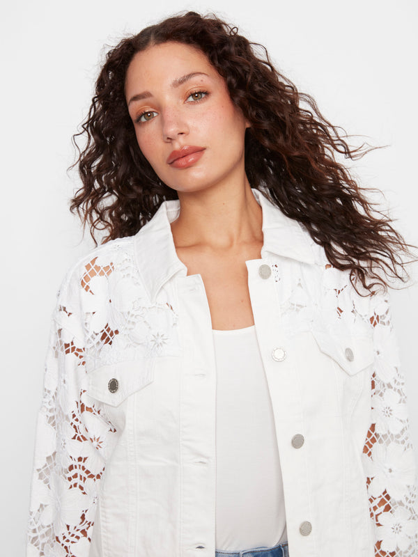 Chic white twill jacket showcasing beautiful welt pockets and detailed floral embroidery on the sleeves by Charlie B.